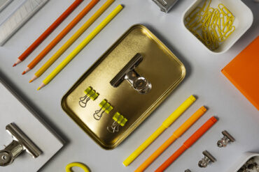 Sur un bureau, des outils de travail comme des pinces, des crayons et des feutres